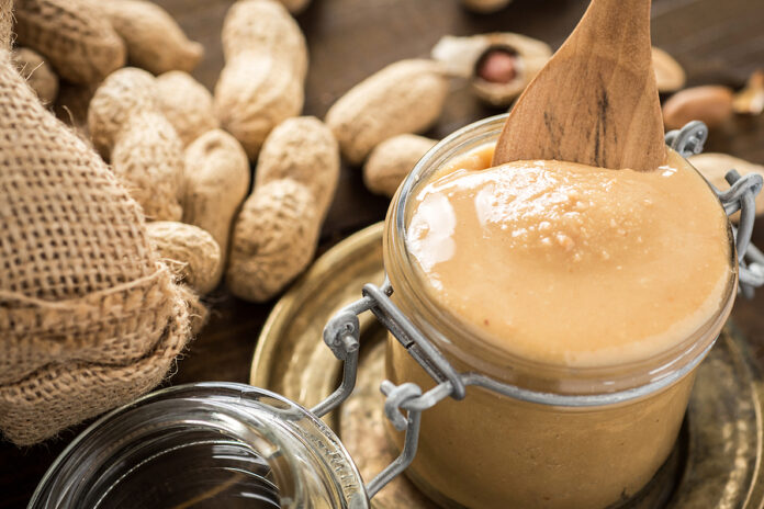 Peanut Butter In Glass Jar With Peanuts