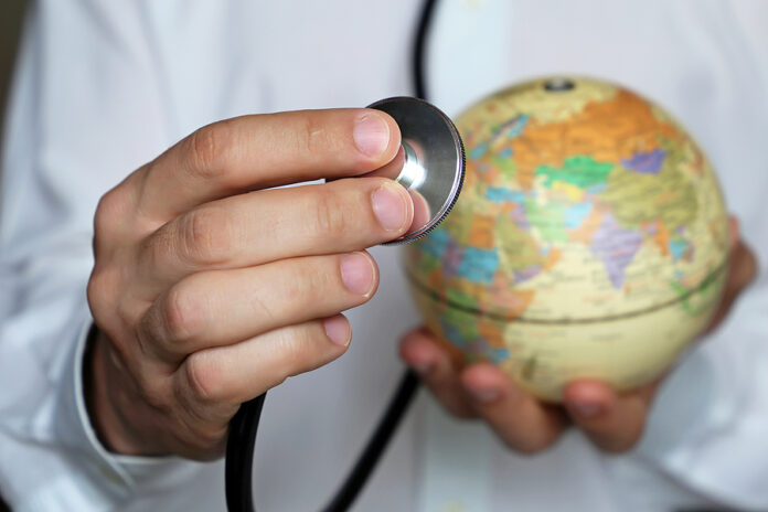 Doctor with stethoscope and globe in his hand